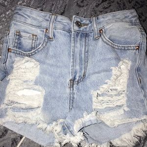 a pair of ripped shorts size 00/23 waist.